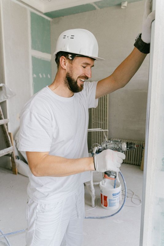 A tradesperson drilling during a renovation