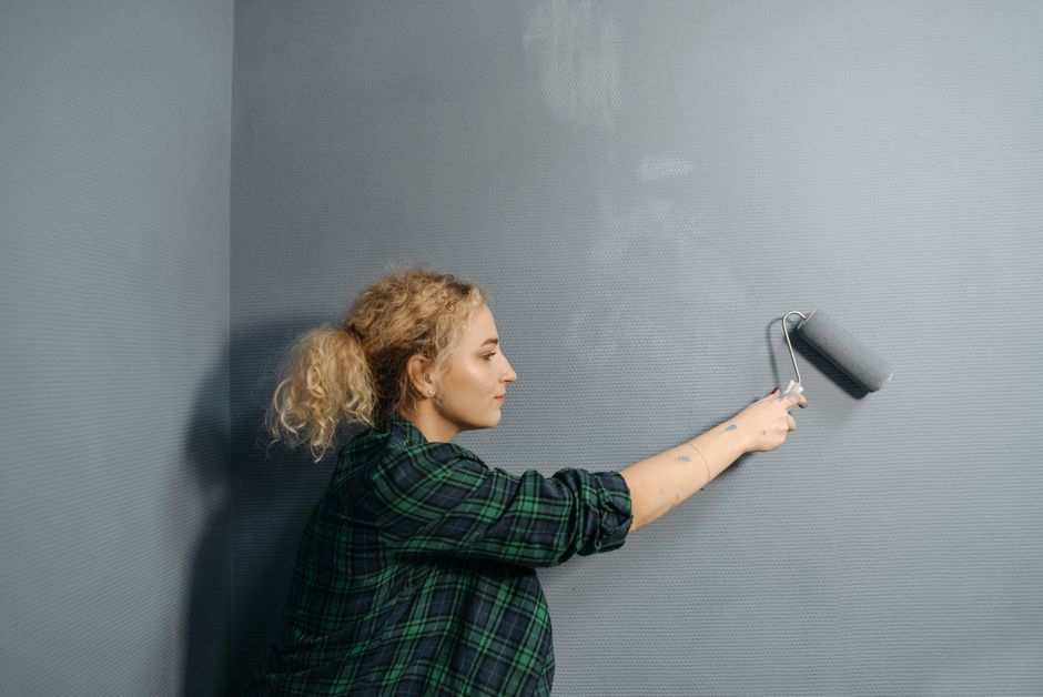 Painter rolling a wall