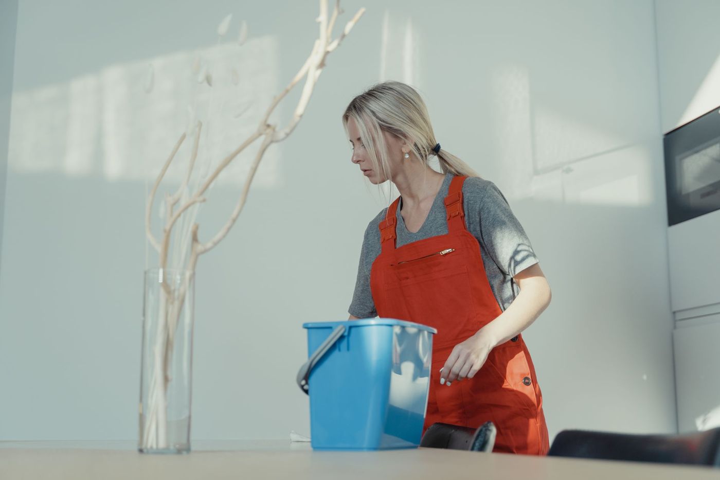 A cleaner wiping down a freshly finished room